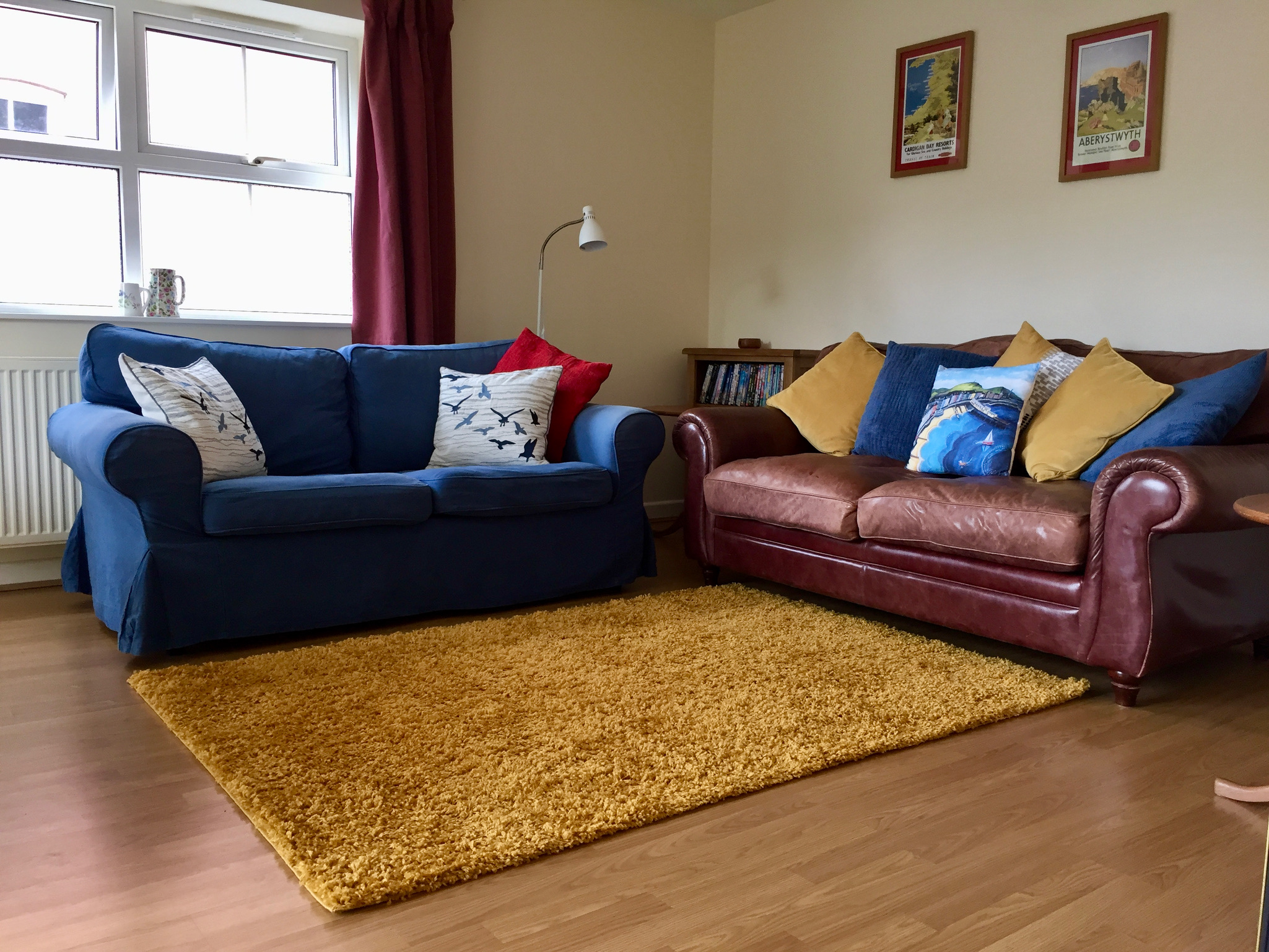 two comfy sofas and a bookcase